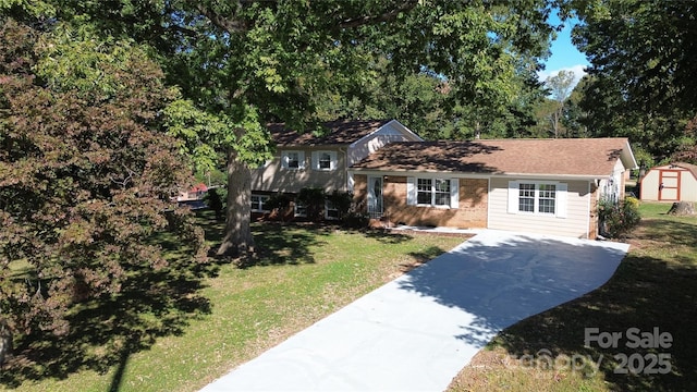 split level home with a storage unit and a front lawn