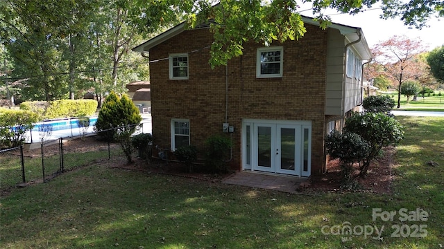 rear view of property with a yard and french doors