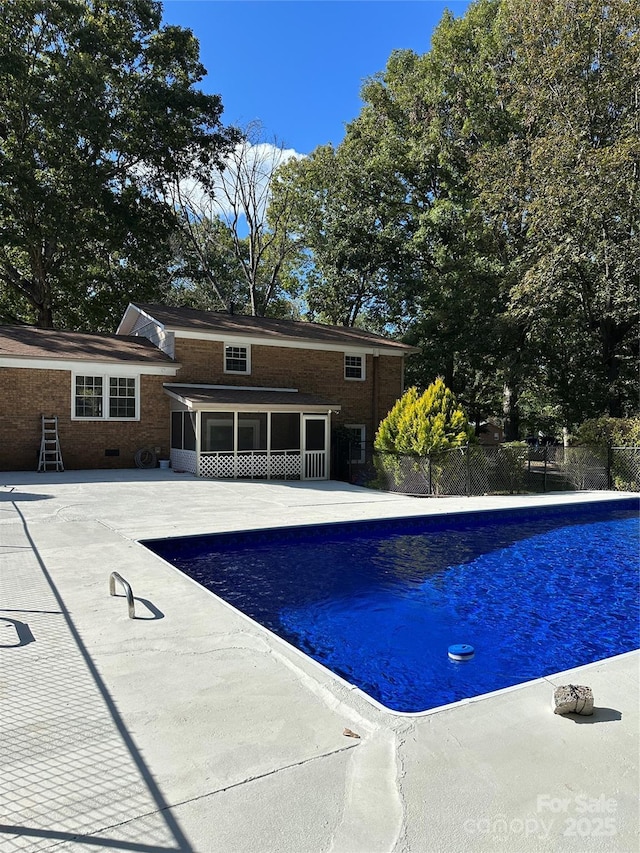 view of pool with a patio area and a sunroom