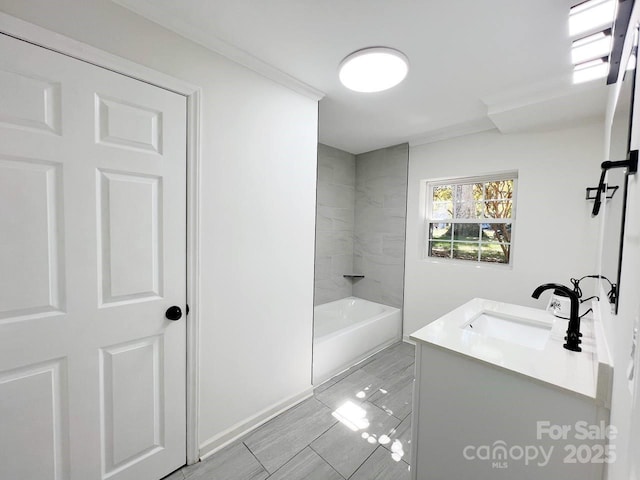 bathroom featuring vanity and tiled shower / bath