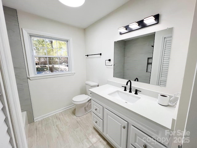 bathroom featuring vanity, walk in shower, toilet, and hardwood / wood-style floors