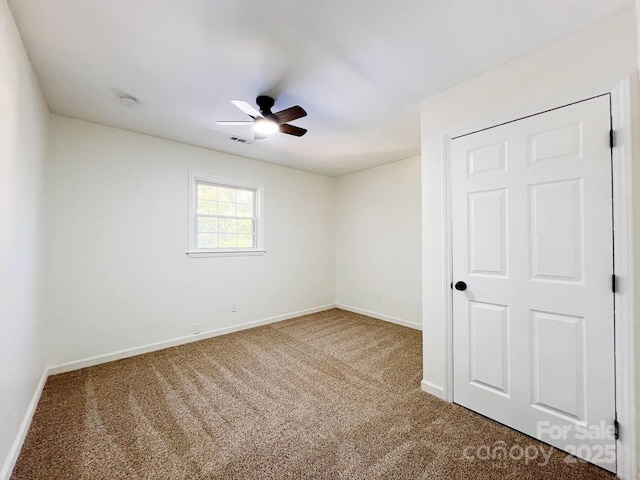 carpeted empty room with ceiling fan