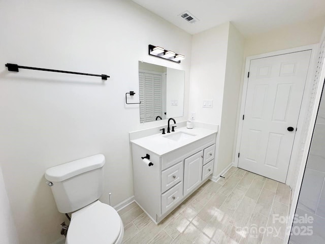 bathroom featuring toilet and vanity