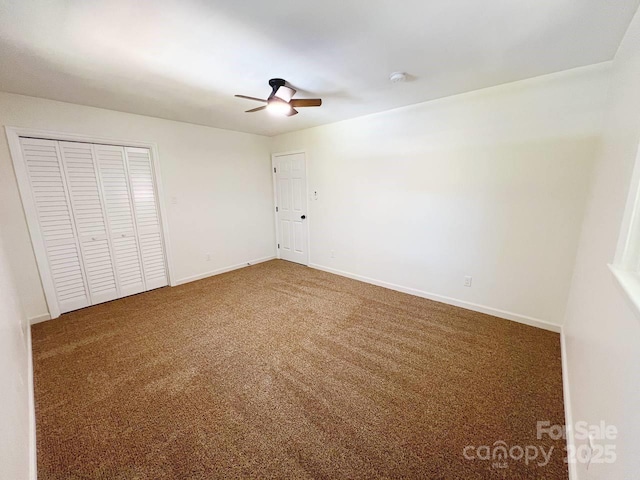 unfurnished bedroom with carpet, a closet, and ceiling fan