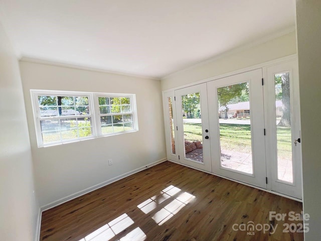 interior space featuring french doors, dark hardwood / wood-style floors, and ornamental molding