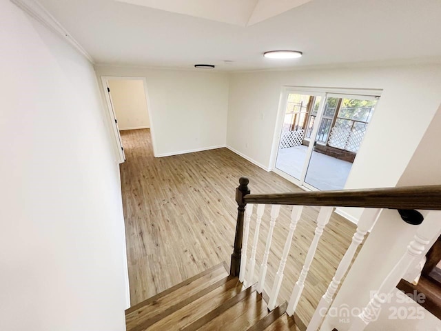 stairway featuring hardwood / wood-style floors and lofted ceiling