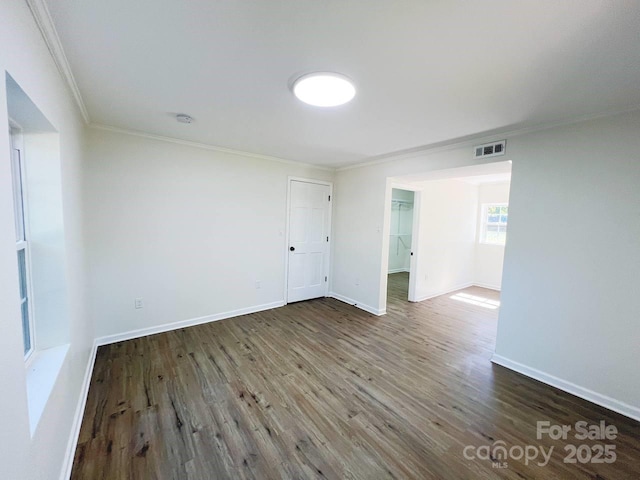 unfurnished room with crown molding and dark hardwood / wood-style floors