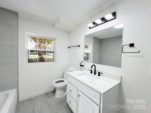 bathroom with toilet, vanity, and ornamental molding