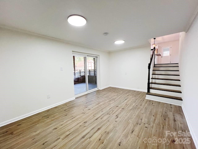 interior space with ornamental molding and light hardwood / wood-style floors