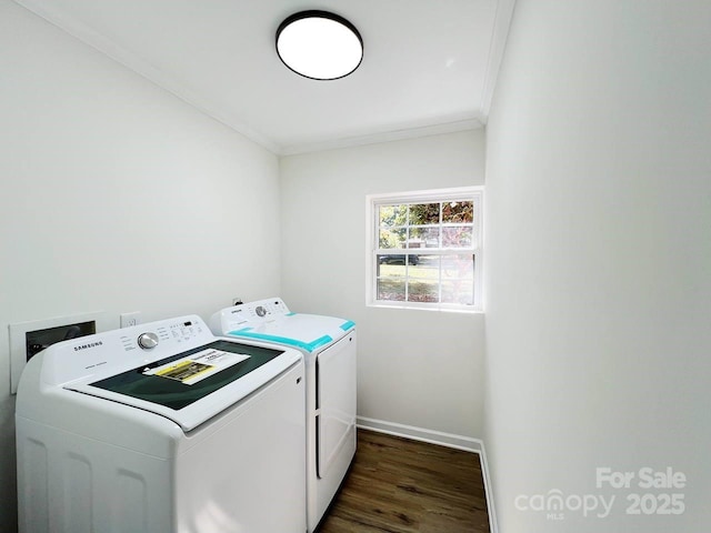 clothes washing area featuring independent washer and dryer, dark hardwood / wood-style flooring, and crown molding