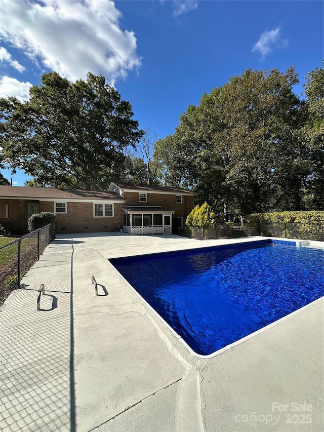 view of swimming pool with a patio area