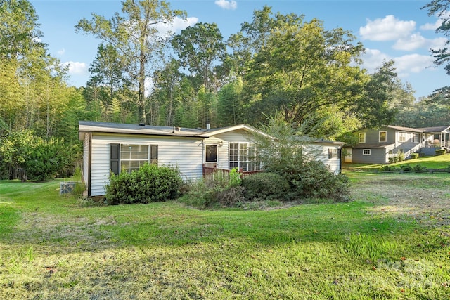 back of property featuring a lawn