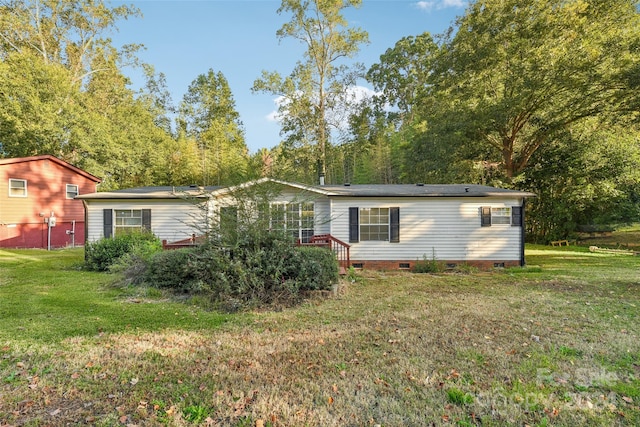 rear view of house featuring a lawn