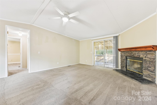 unfurnished living room with carpet flooring, a stone fireplace, ceiling fan, lofted ceiling, and crown molding