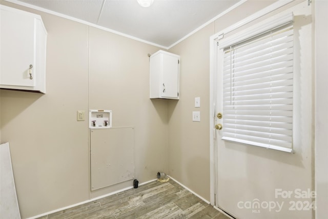 clothes washing area with cabinets, hookup for a washing machine, ornamental molding, and light wood-type flooring