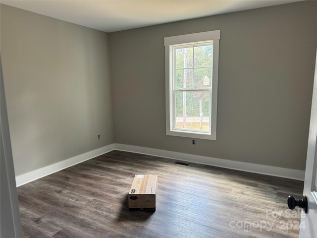 spare room featuring dark hardwood / wood-style floors