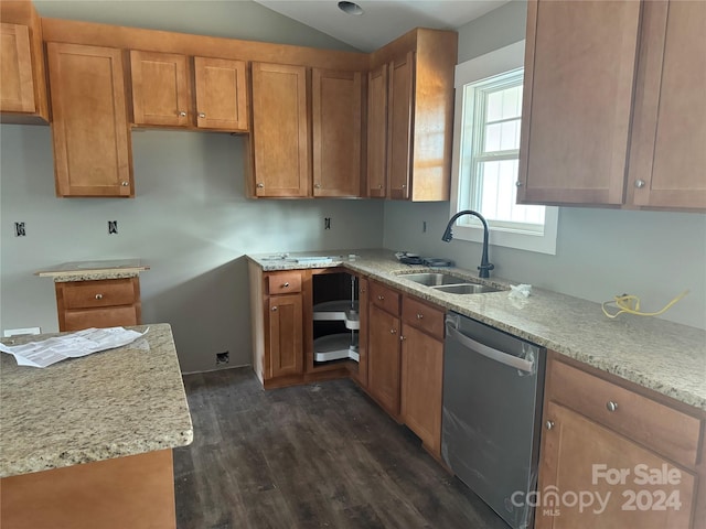 kitchen featuring light stone counters, stainless steel dishwasher, dark wood-type flooring, sink, and lofted ceiling