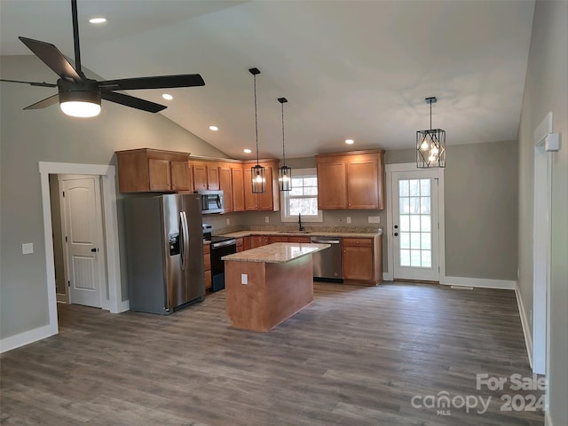 kitchen with a center island, dark wood-type flooring, ceiling fan with notable chandelier, vaulted ceiling, and appliances with stainless steel finishes