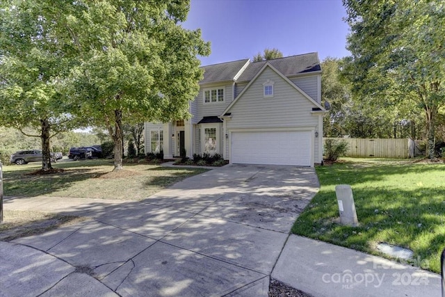 view of front of property with a front lawn and a garage