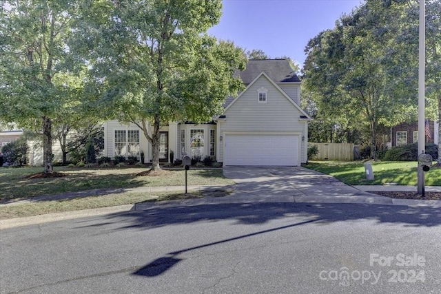 view of front facade with a front yard and a garage