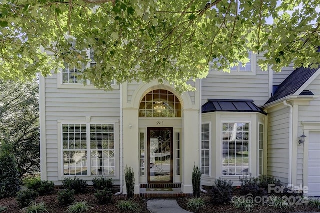 view of exterior entry with a garage