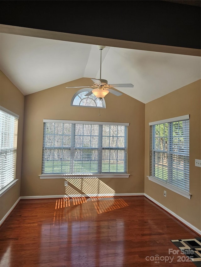 unfurnished room featuring ceiling fan, plenty of natural light, hardwood / wood-style floors, and lofted ceiling