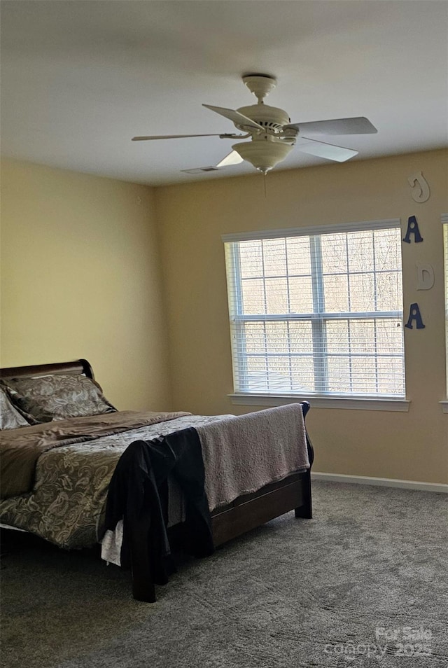 bedroom featuring ceiling fan and carpet