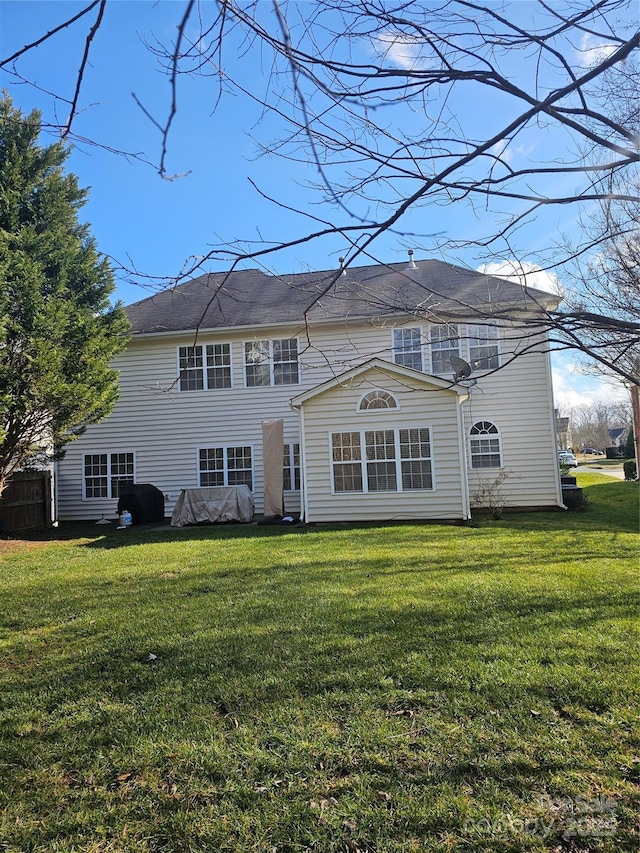 back of house featuring a lawn