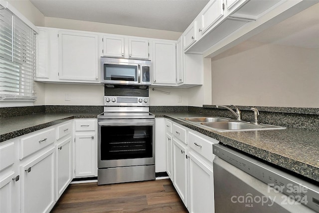 kitchen featuring white cabinets, dark hardwood / wood-style floors, sink, and appliances with stainless steel finishes