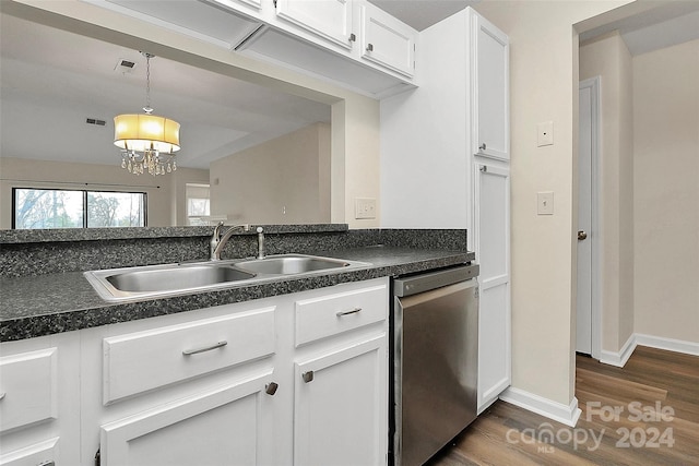 kitchen with pendant lighting, dark wood-type flooring, sink, stainless steel dishwasher, and white cabinetry