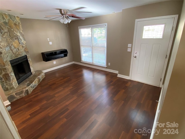 entryway with a fireplace, dark hardwood / wood-style floors, and ceiling fan