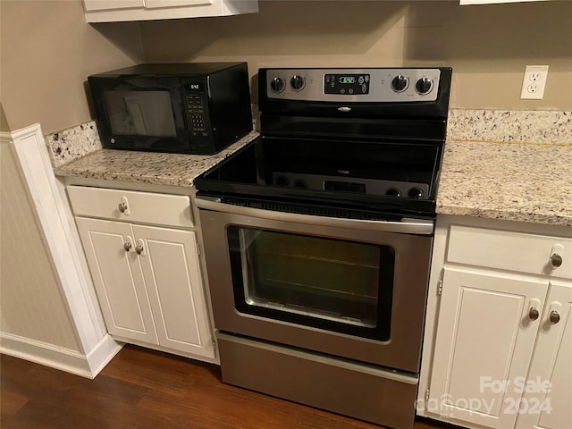 kitchen featuring light stone counters, white cabinets, stainless steel range with electric stovetop, and dark hardwood / wood-style flooring