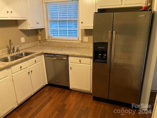 kitchen featuring dark hardwood / wood-style floors, stainless steel appliances, sink, white cabinetry, and light stone counters