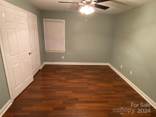 unfurnished bedroom featuring dark hardwood / wood-style flooring and ceiling fan