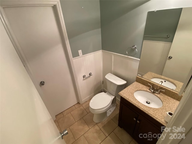 bathroom featuring vanity, toilet, and tile patterned floors