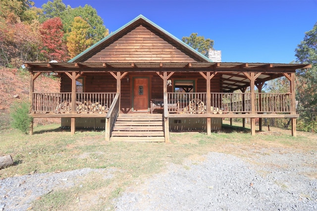 log cabin with covered porch