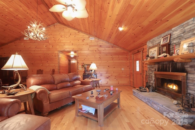 living room featuring vaulted ceiling, wooden ceiling, and light wood-type flooring