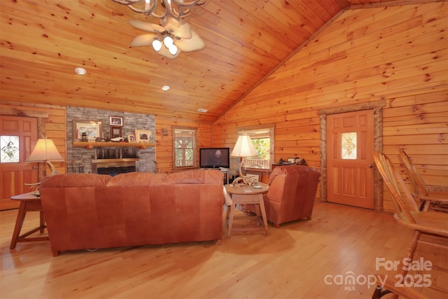 living room with wood ceiling, lofted ceiling, a fireplace, and light hardwood / wood-style flooring