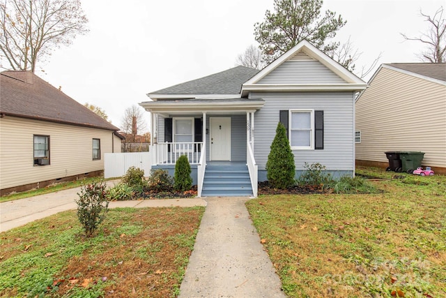 bungalow featuring a porch and a front lawn