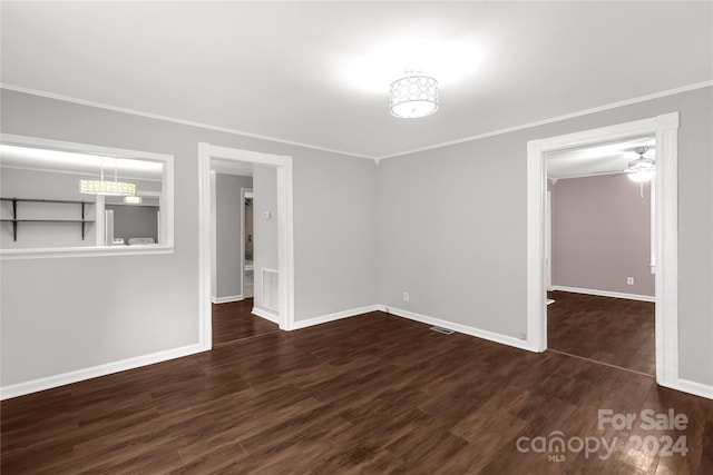 unfurnished room featuring ornamental molding, ceiling fan, and dark wood-type flooring