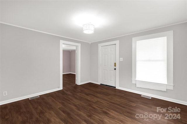 foyer with dark hardwood / wood-style floors and ornamental molding