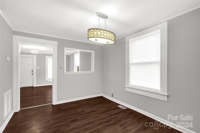 spare room featuring dark hardwood / wood-style floors and ornamental molding