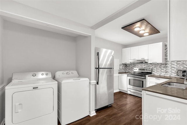 laundry area featuring washer and clothes dryer, sink, and dark wood-type flooring