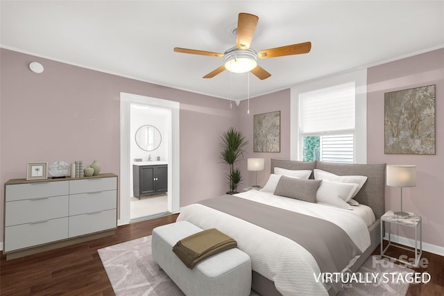 bedroom featuring sink, dark hardwood / wood-style flooring, ceiling fan, and connected bathroom