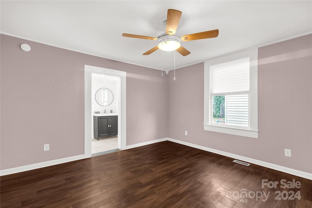 unfurnished room featuring ceiling fan, hardwood / wood-style floors, and sink