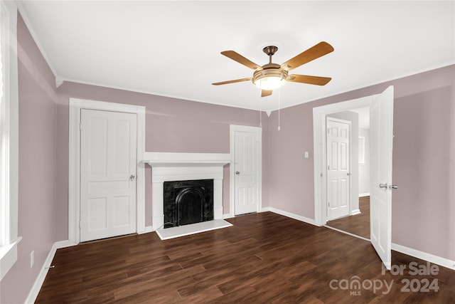 unfurnished living room featuring dark hardwood / wood-style flooring, ceiling fan, and ornamental molding