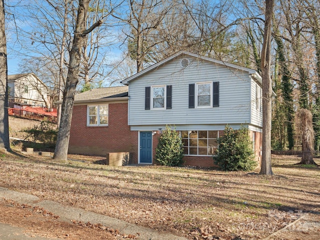 tri-level home with a front lawn