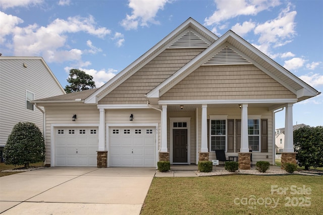 craftsman-style house with a porch, a garage, and a front lawn