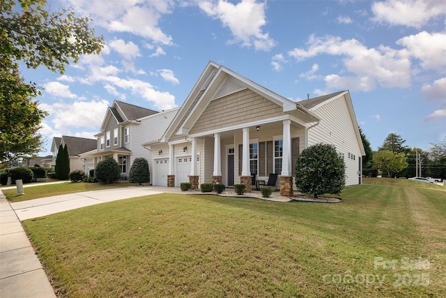 craftsman inspired home featuring a front yard, a porch, and a garage