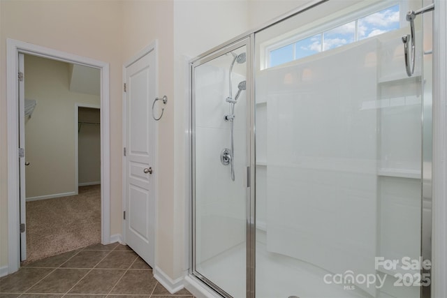 bathroom with tile patterned flooring and a shower with shower door